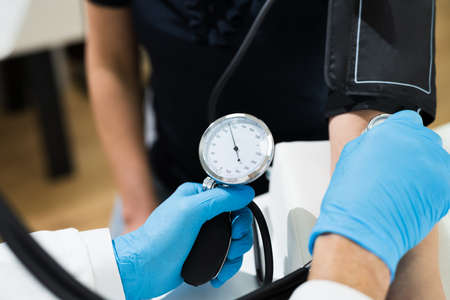 Measuring Blood Pressure. Health Check In Face Mask