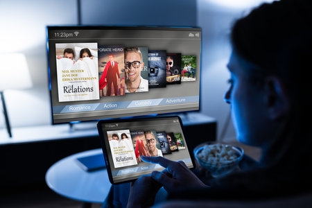 Woman Watching TV Through Tablet Television And Movie Streaming
