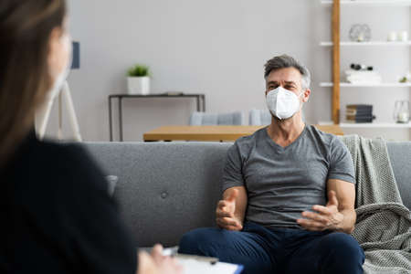 Psychiatrist Or Psychology Psychologist With Clipboard And Face Mask