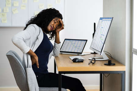 African Back Pain At Work Desk. Posture Problem