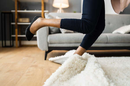 Falldown Hazard. Clumsy Woman Stumbled On Rugの写真素材