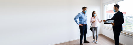 Realtor Showing New Real Estate House In Face Maskの写真素材