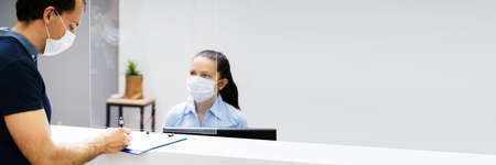 Hotel Reception Counter Or Desk With Face Maskの写真素材