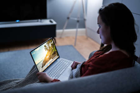 Watching TV Video On Laptop Online On Couchの写真素材