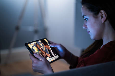 Watching TV Video On Laptop Online On Couchの写真素材