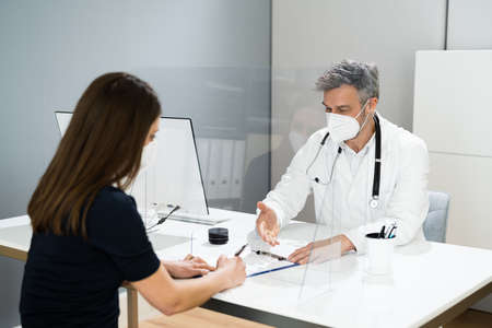 Pregnant Woman Meeting With Doctor With Face Maskの写真素材