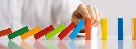 Falling Domino Stop. Fall Prevention. Hand Stoppingの写真素材