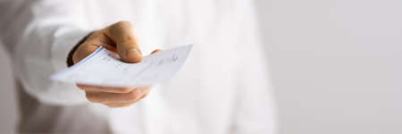 Giving Paycheck Or Payroll Cheque. Rent Check Payの写真素材