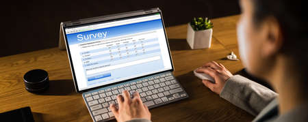 Woman Filling Survey Form On Tablet Screen