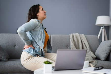 Lower Back Pain. Bad Posture Sitting On Couch