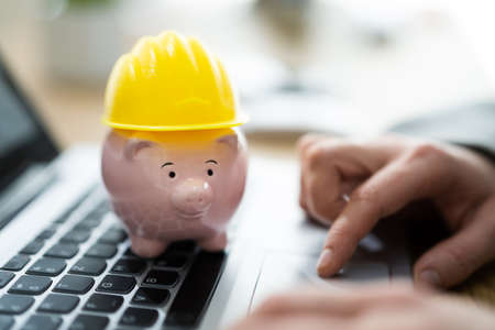 Piggy Bank With Hard Hat Or Safety Construction Securityの写真素材