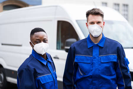 Electrician Technician Or Plumber In Workwear And Face Mask Near Van