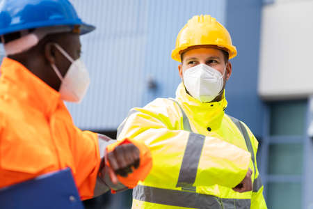 Construction Industry People Teamwork Elbow Bump Greeting