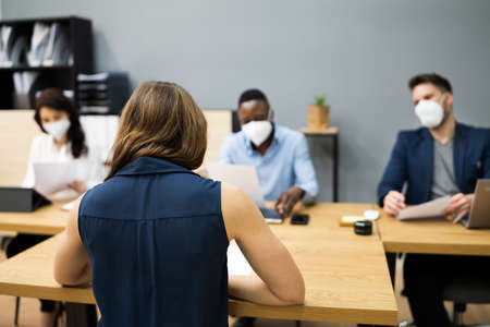 Business Manager Job Interview Talking In Face Maskの写真素材