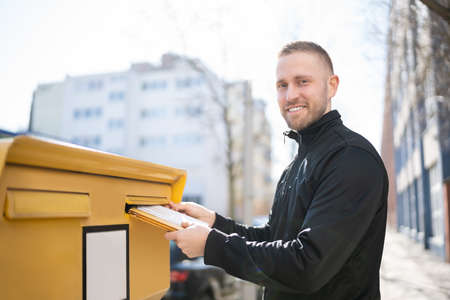 Letter In Envelope Or Document In Mailbox. Man Sending Mailの写真素材