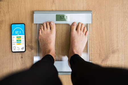 Woman Using Smart Weight Scale Measurement Techの写真素材