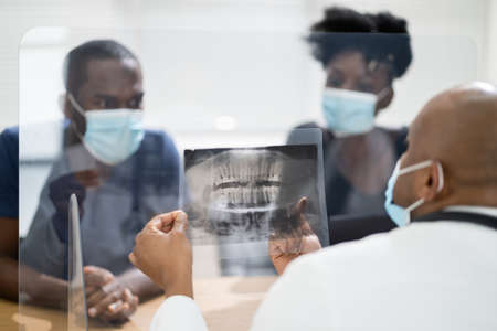 Patient Consulting At Dentist. General Dental Discussion In Face Maskの写真素材