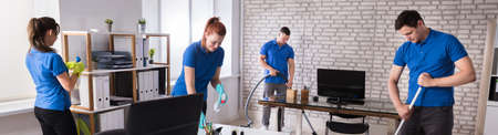 Group Of Janitors Cleaning The Office With Caution Wet Floor Signの写真素材
