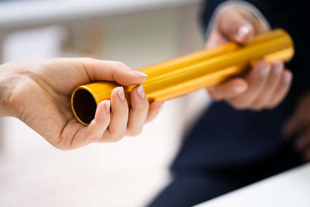 Business Man And Woman Relay Baton Handover And Pass