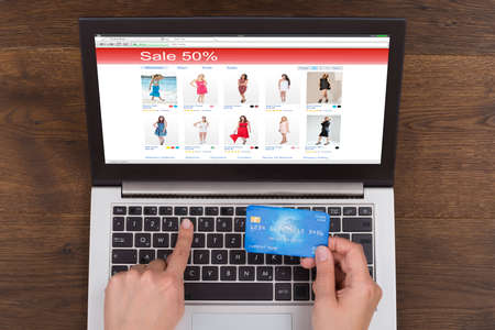 Person Hands Shopping Online With Credit Card And Laptop At Deskの写真素材