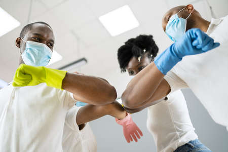 Janitor Cleaner Team In Uniform doing Elbow Bump