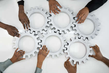 Business People Team Hands Connecting Gears. Implementation And Collaborationの写真素材