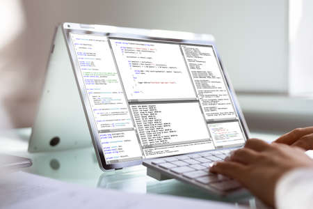 African American Woman Coder Using Laptop Software