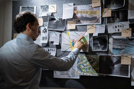 Policeman Or Private Detective Searching Crime Investigation Board