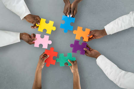 African Medical Doctor Group Holding Puzzle Together