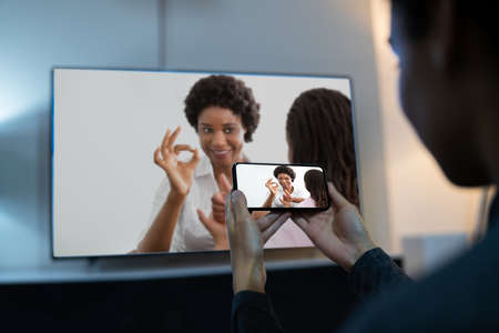 Woman Watching TV Through Smartphone And Streaming Movie