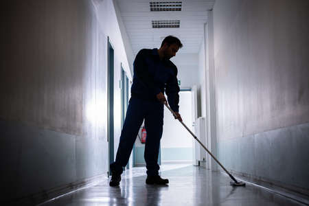 Professional Office Janitor Worker Cleaning Floor With Mop