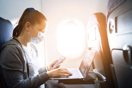 Business Flight Passenger On Airplane Using Laptop