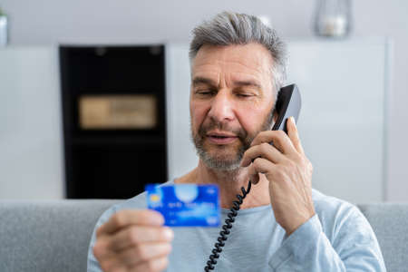 Card Credit Phone Fraud And Older Man Scamの写真素材