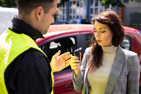 Policeman Doing Driver Alcohol Testの写真素材