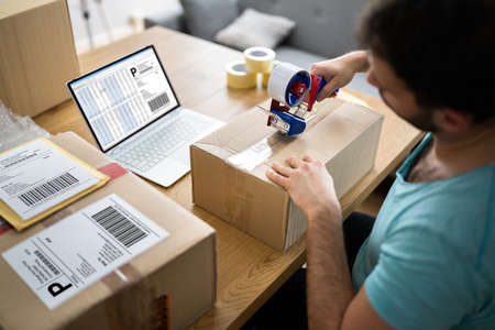 Person Packaging Parcels For Online Delivery To Customers