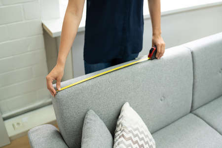 Woman Doing Sofa Or Couch Furniture Repair And Installation