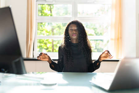 Healthy Yoga Meditation At Workplace. Meditating Business Womanの写真素材