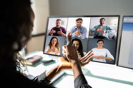 African American Using Sign Language For Deaf Disability In Video Conferenceの写真素材