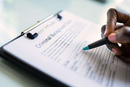 Hand Filling Criminal Background Check Application Formの写真素材