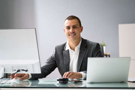 Happy Professional African Employee Using Computer In Office