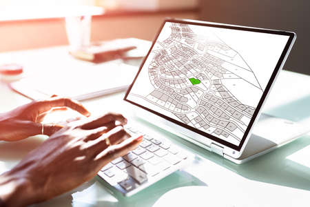 Female Executive Looking At Cadastre Map On Screenの写真素材