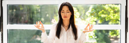 Healthy Woman Meditation Sitting Near Window. Calm Morning