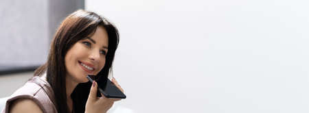 Woman Talking Using Voice Control And Assistantの写真素材