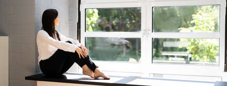 Beautiful Female Girl Resting Near Window. Young People Lifestyle