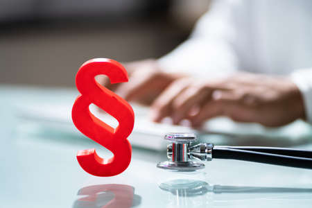 Medical Malpractice In Healthcare. Stethoscope And Paragraphの写真素材