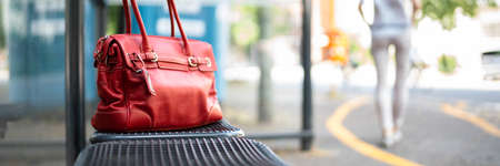 Lost Woman Bag Or Purse At Busstop In Transitの写真素材