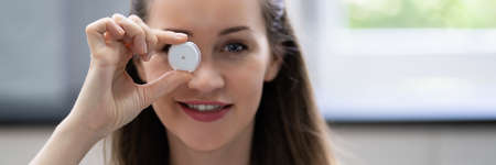 Woman Holding Continuous Glucose Monitor For Testing Glucose Level