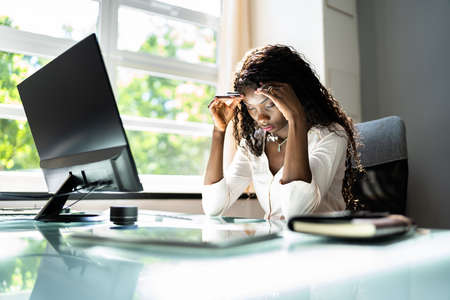 Stressed Sick African American Employee Woman At Computerの写真素材