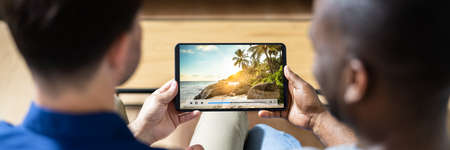 Watching Online Movie Holding Tablet. African Americanの写真素材