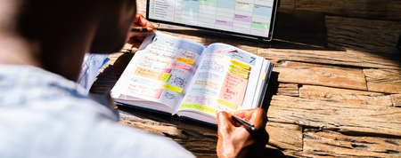 Meeting Agenda And Schedule Plan Organizer. African American Using Plannerの写真素材
